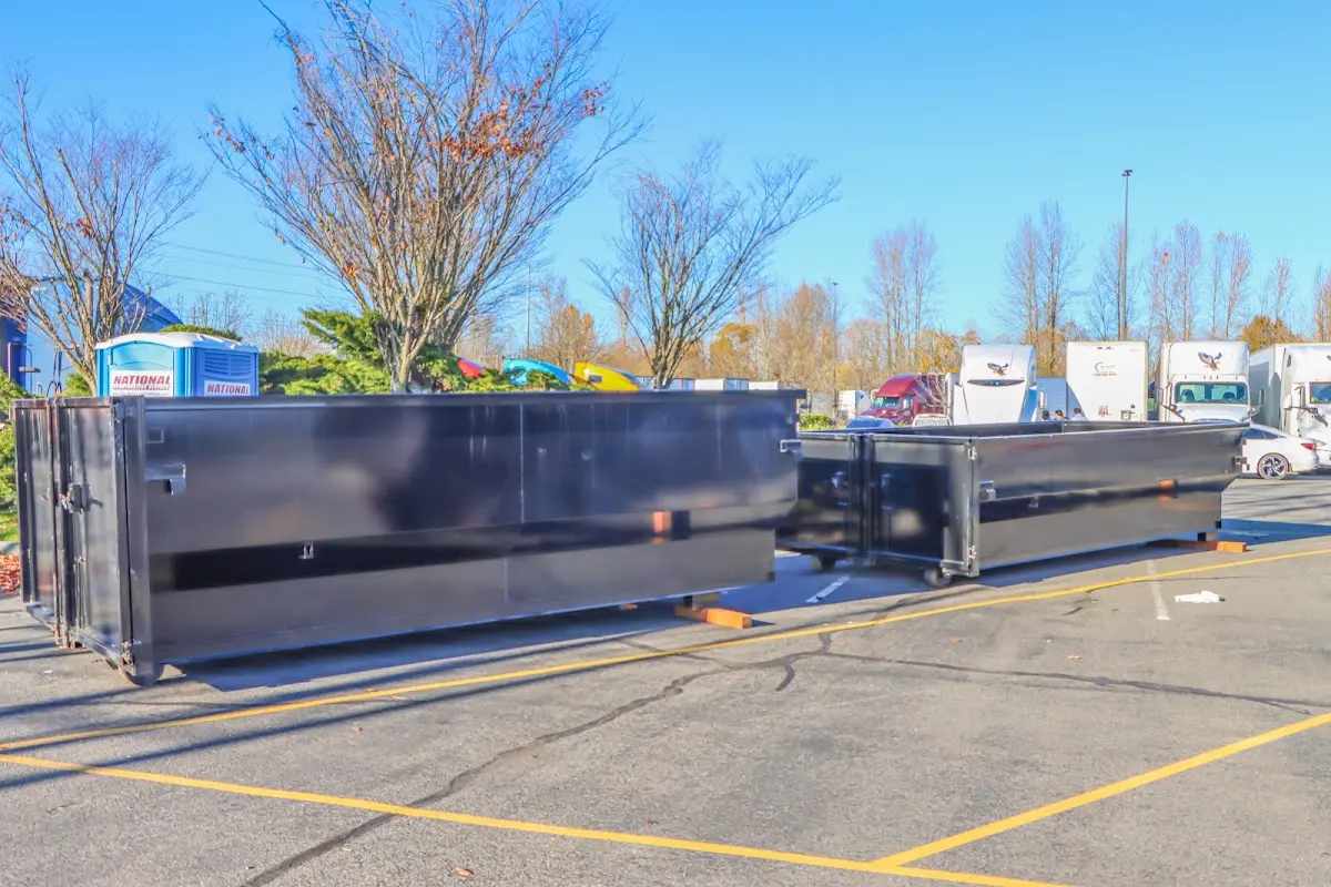 Professional dumpster rental service with roll-off container on residential driveway in Iowa City